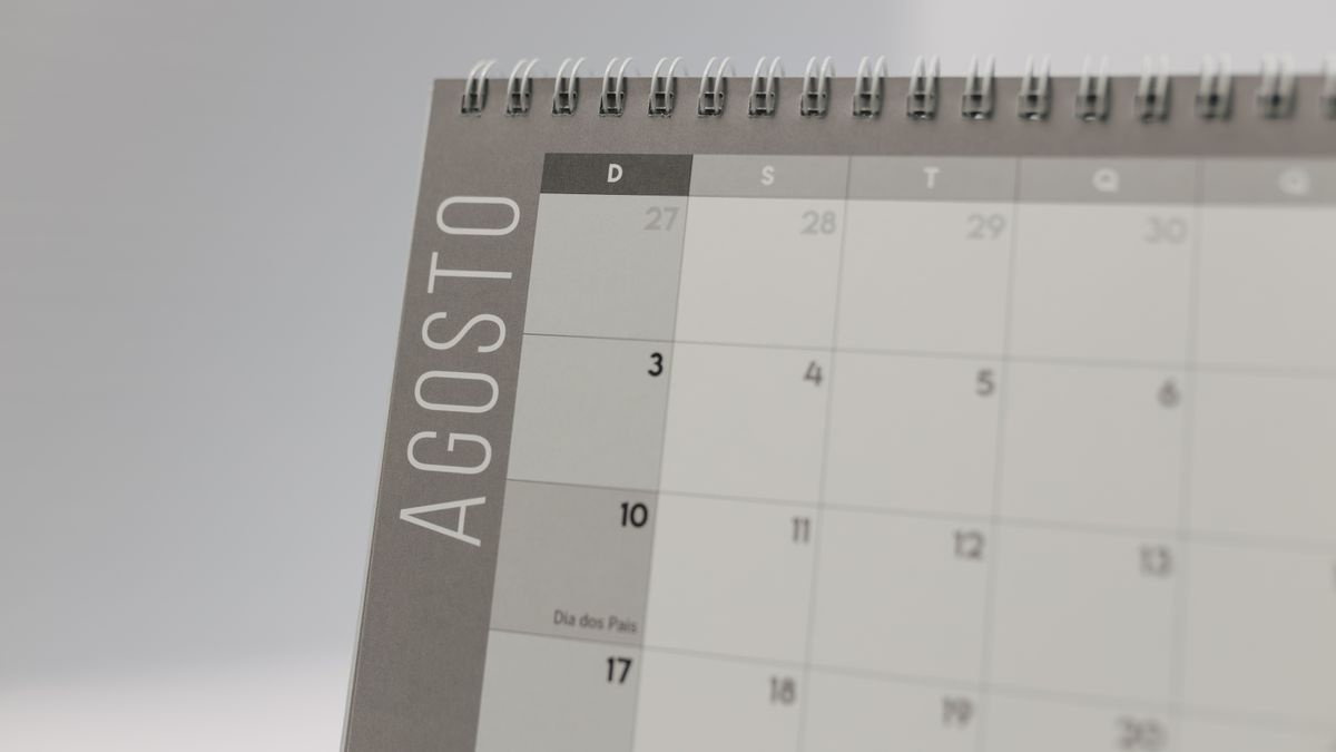 Close-up of a spiral-bound calendar highlighting August dates.