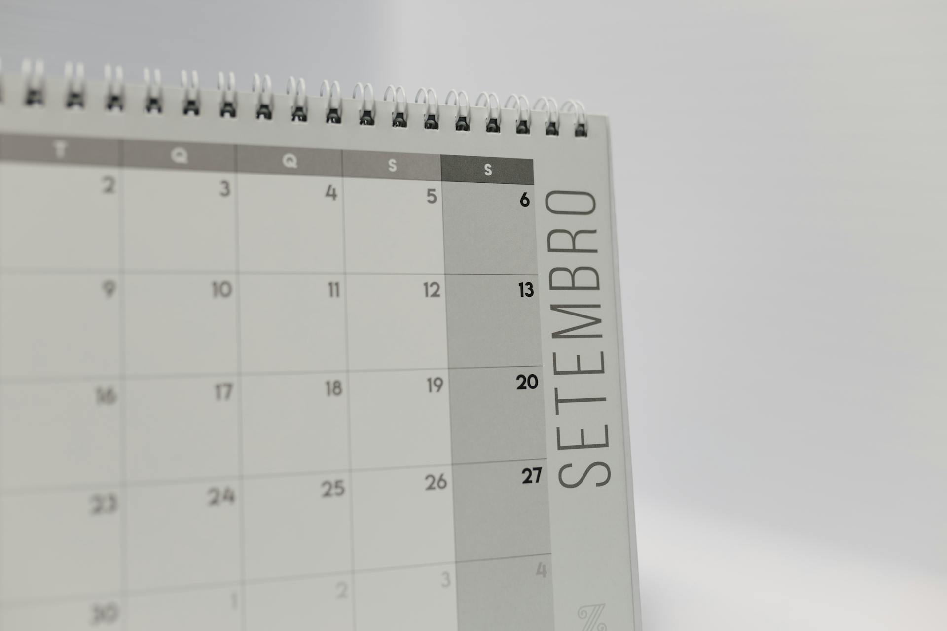 A desk calendar displaying the month of September with a spiral binding, in a minimalist design.