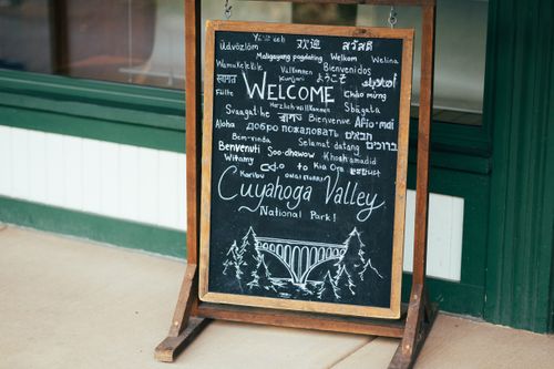 Free Chalkboard sign welcoming visitors to Cuyahoga Valley National Park in various languages. Stock Photo