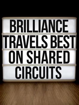 Lightbox displaying the inspirational quote 'Brilliance Travels Best on Shared Circuits.'