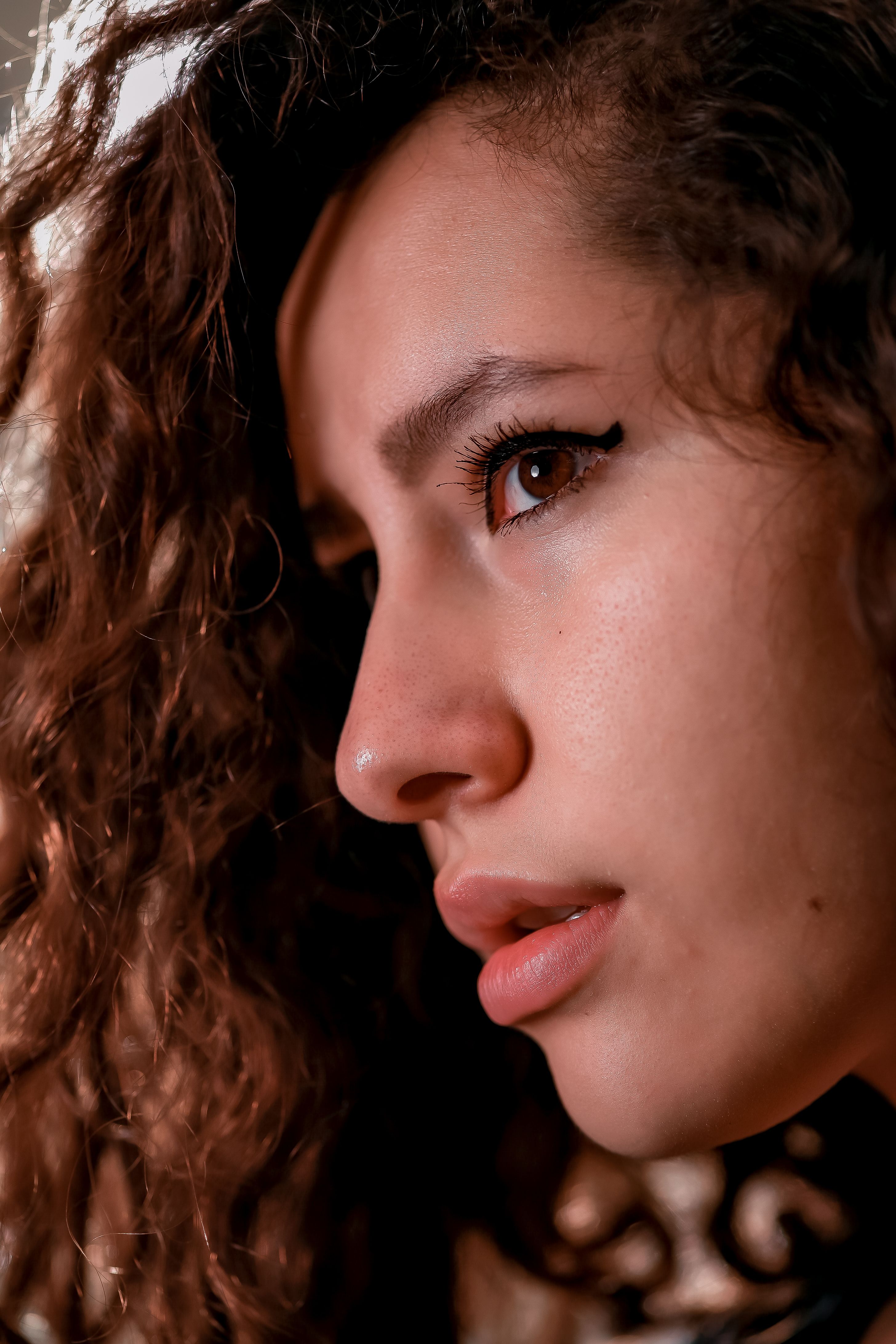 Close-up Portrait of a Woman with Curly Hair · Free Stock Photo