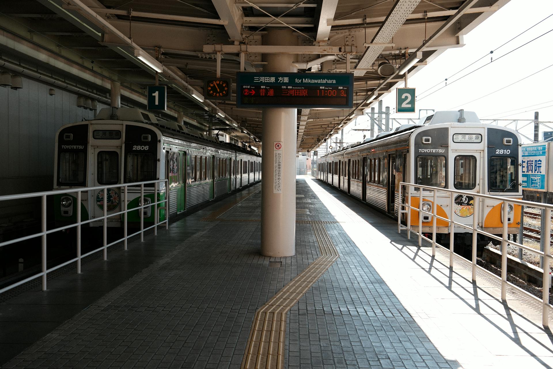 Two Toyotetsu trains at Toyohashi Station in Japan on a sunny day.