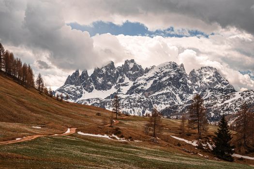 Majestic view of snow-capped mountains under cloudy skies in the Alps.
