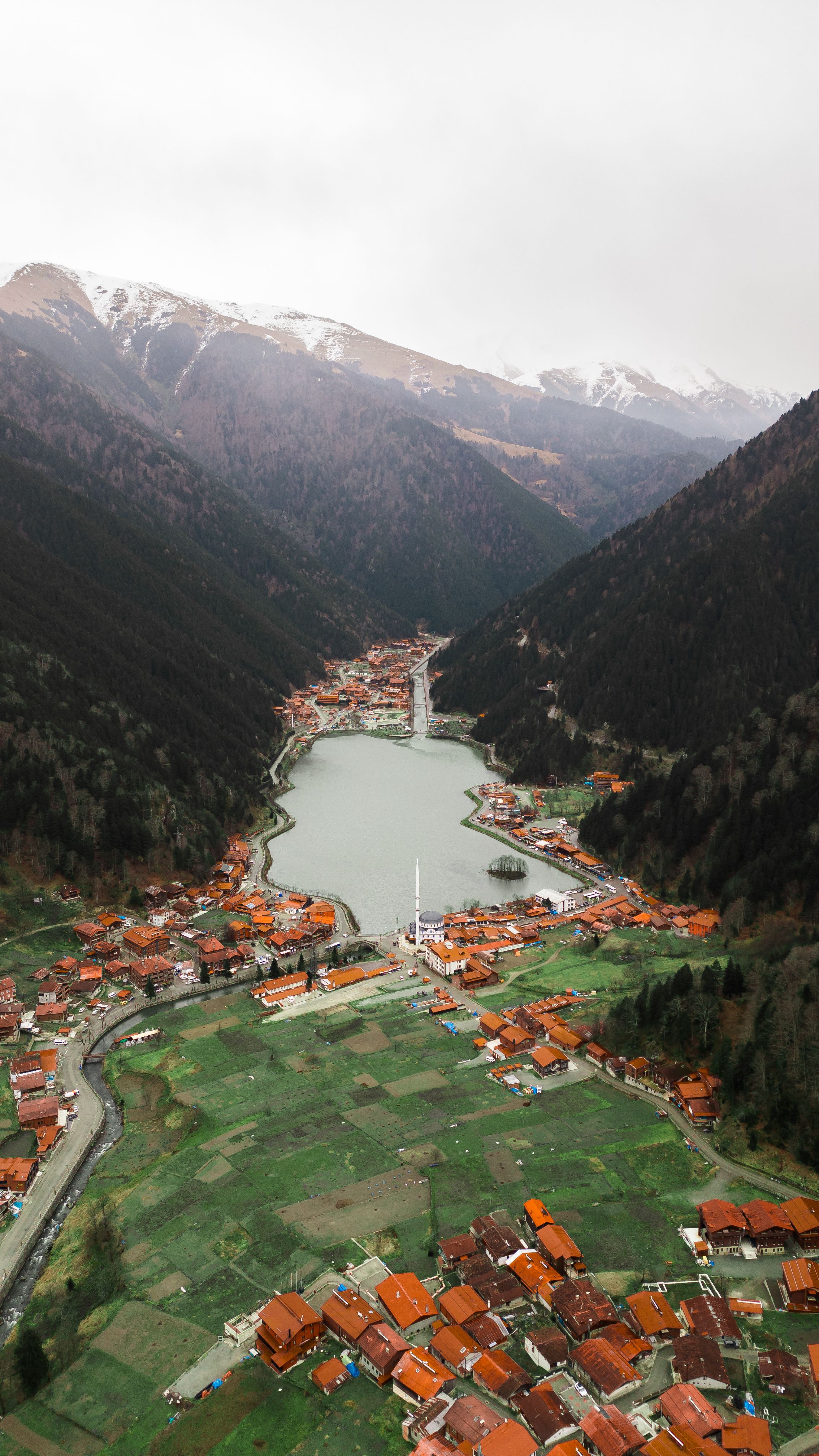 Serene view of Uzungöl Lake and surrounding misty mountains