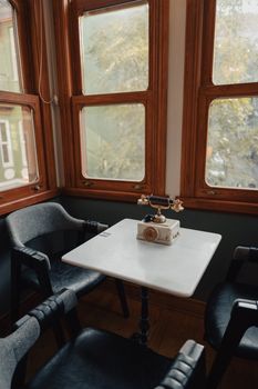 A quaint café corner in İstanbul with a vintage phone and retro decor, exuding charm.