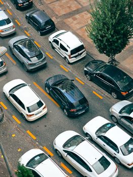 Top view of cars stuck in heavy traffic on a city street.