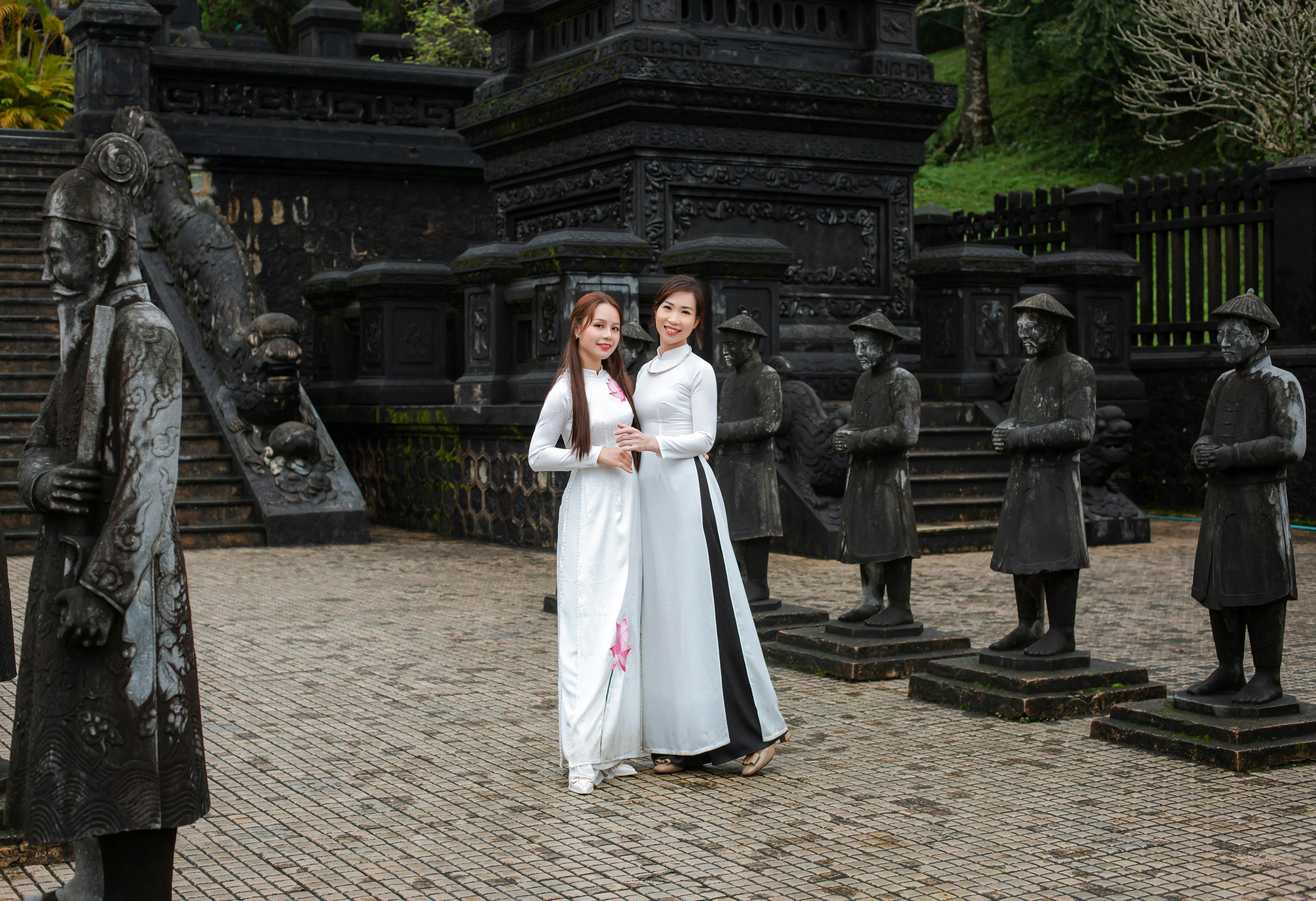Two women in áo dài at the historic Khai Dinh Tomb in Huế, Vietnam. - Hue