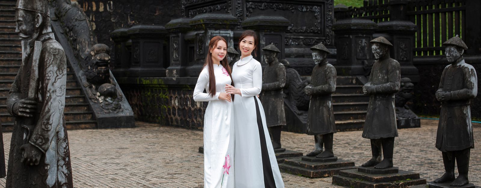 Two women in áo dài at the historic Khai Dinh Tomb in Huế, Vietnam.
