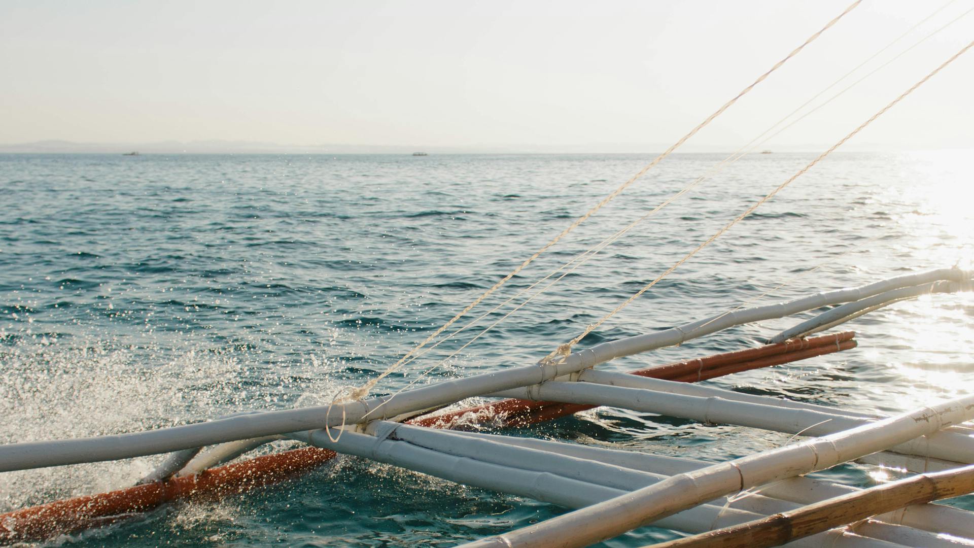 A sailing adventure on a traditional Philippine boat, capturing ocean waves and serene seascapes.