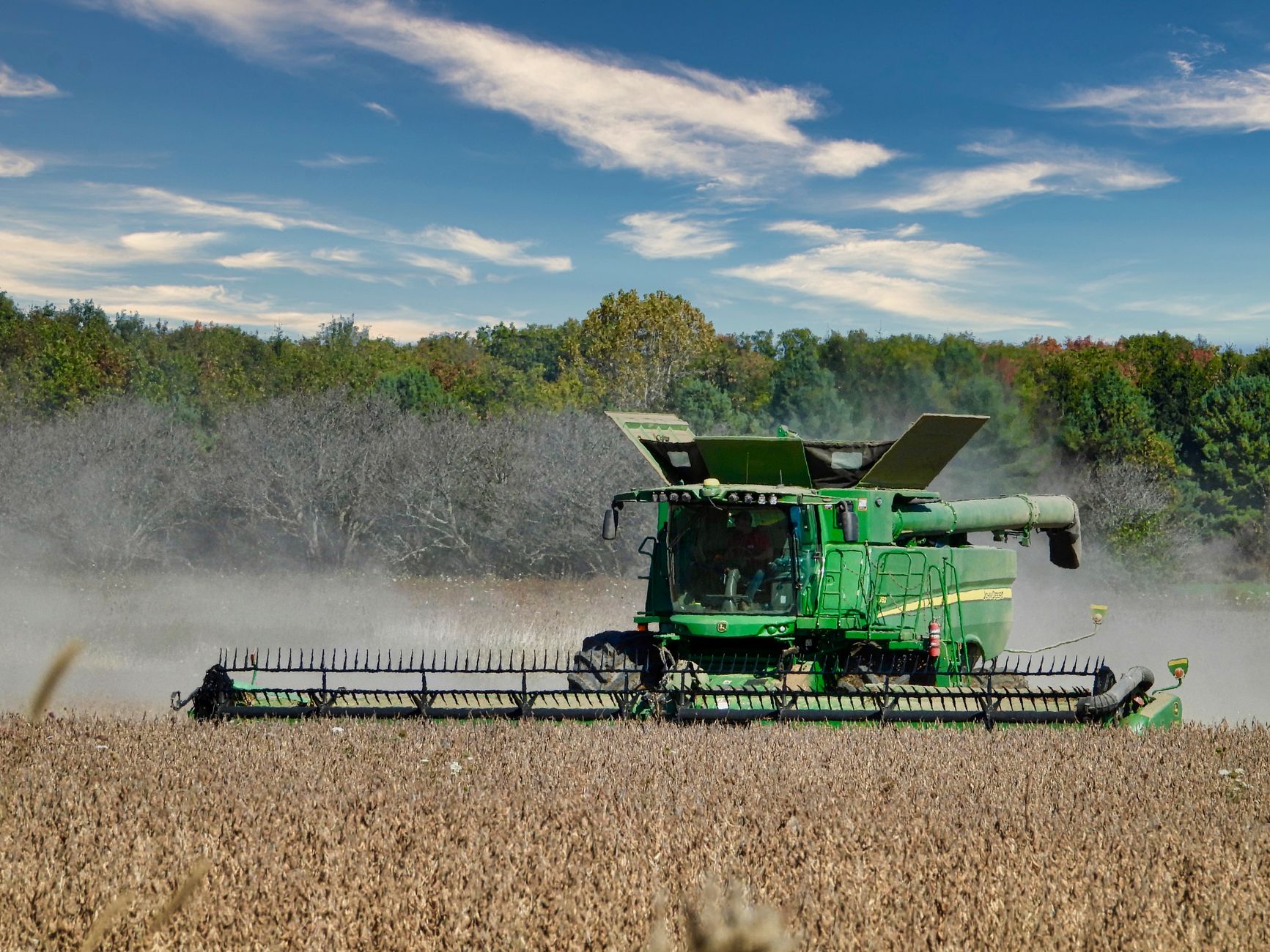 Combine harvester working in a soybean field in Ontario, Canada.