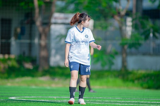 A female soccer player in uniform on a sunny day in Hà Nội, Vietnam.