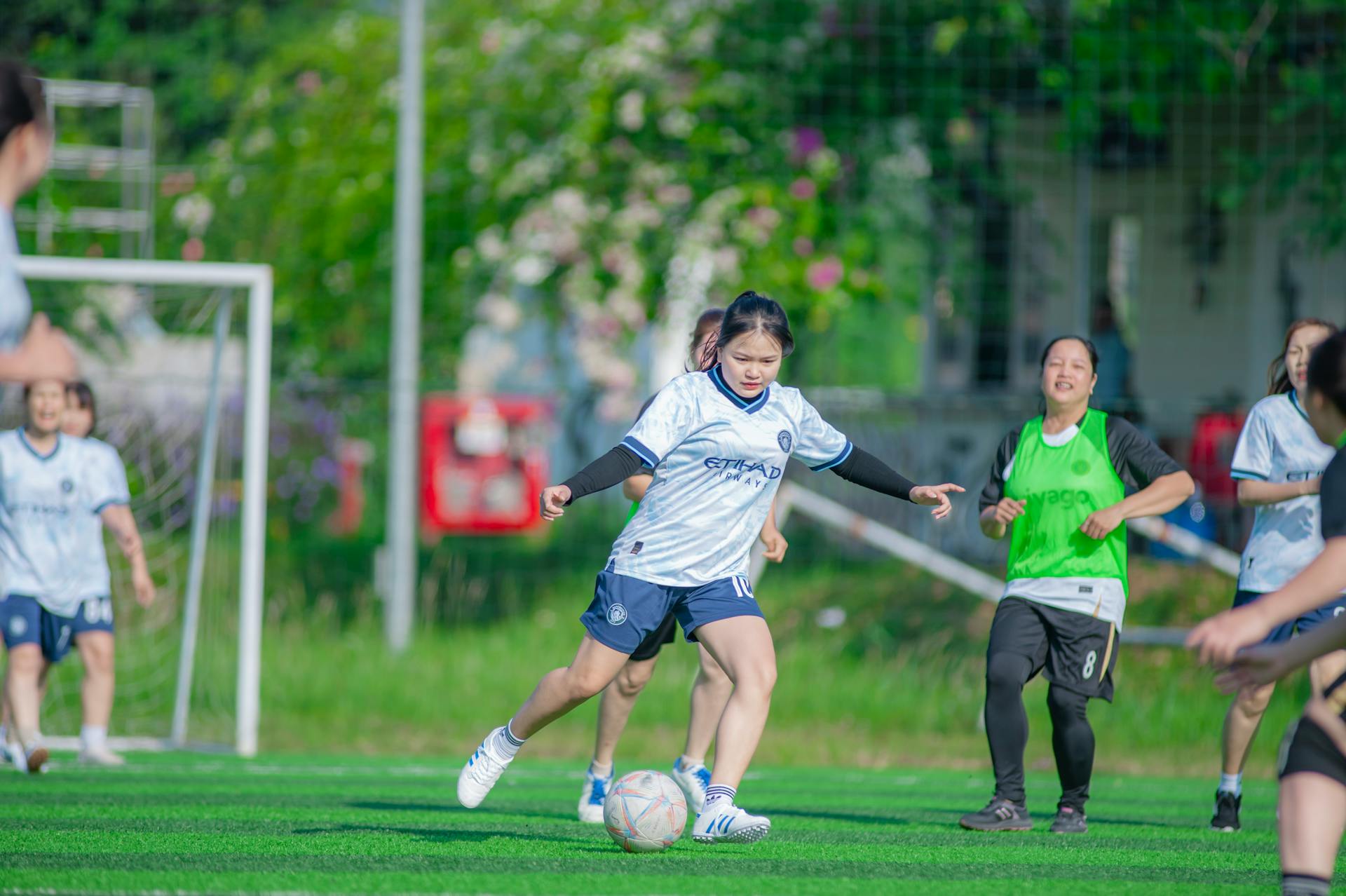 Action-packed women's soccer game in Hanoi, showcasing teamwork and energy.