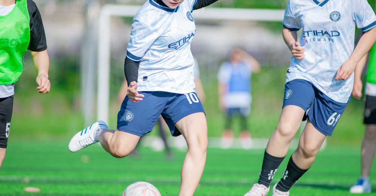 Female soccer players in action during a match in Hanoi, showcasing athleticism and teamwork.