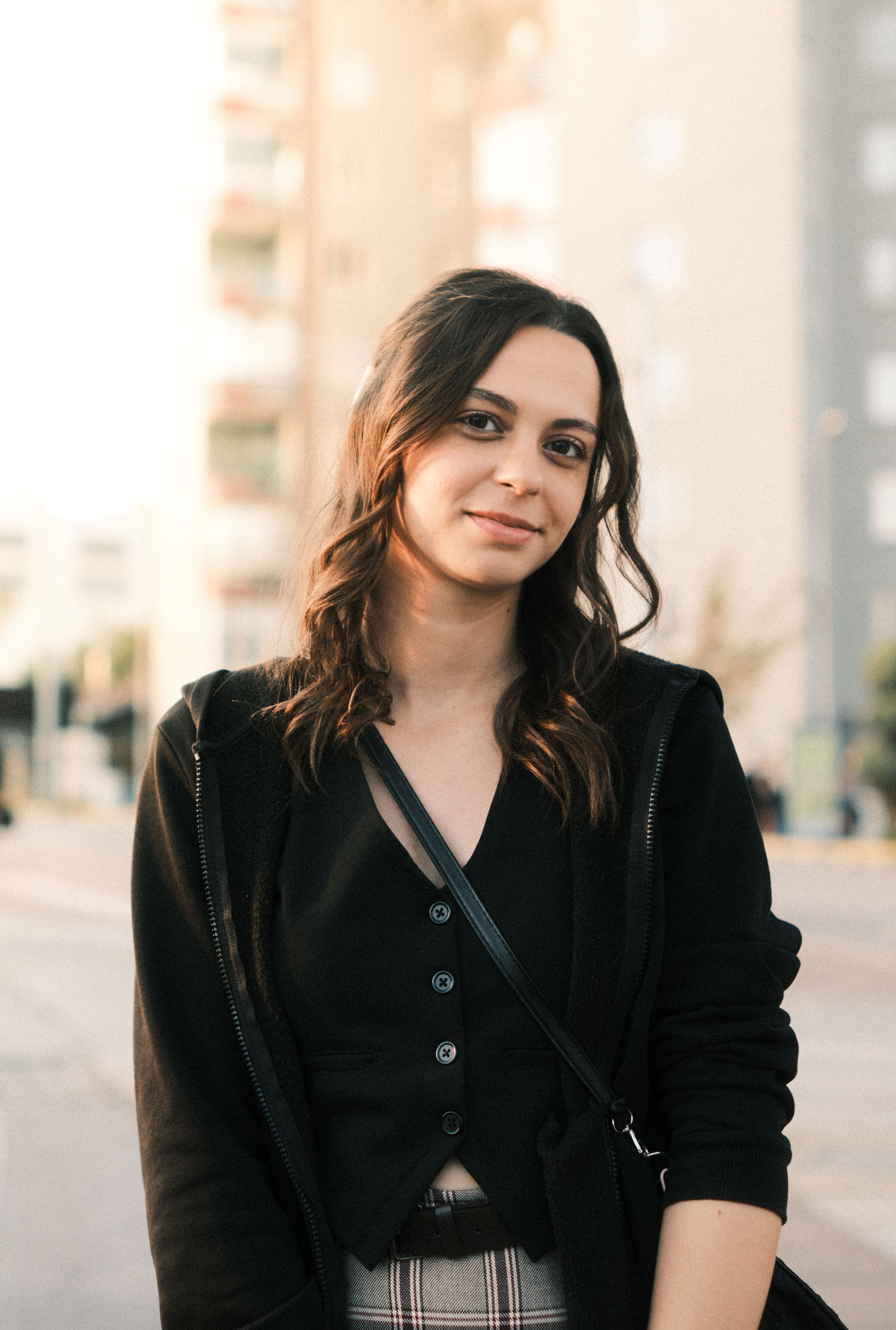 Casual portrait of a young woman on a bright street in Eskişehir, Türkiye.