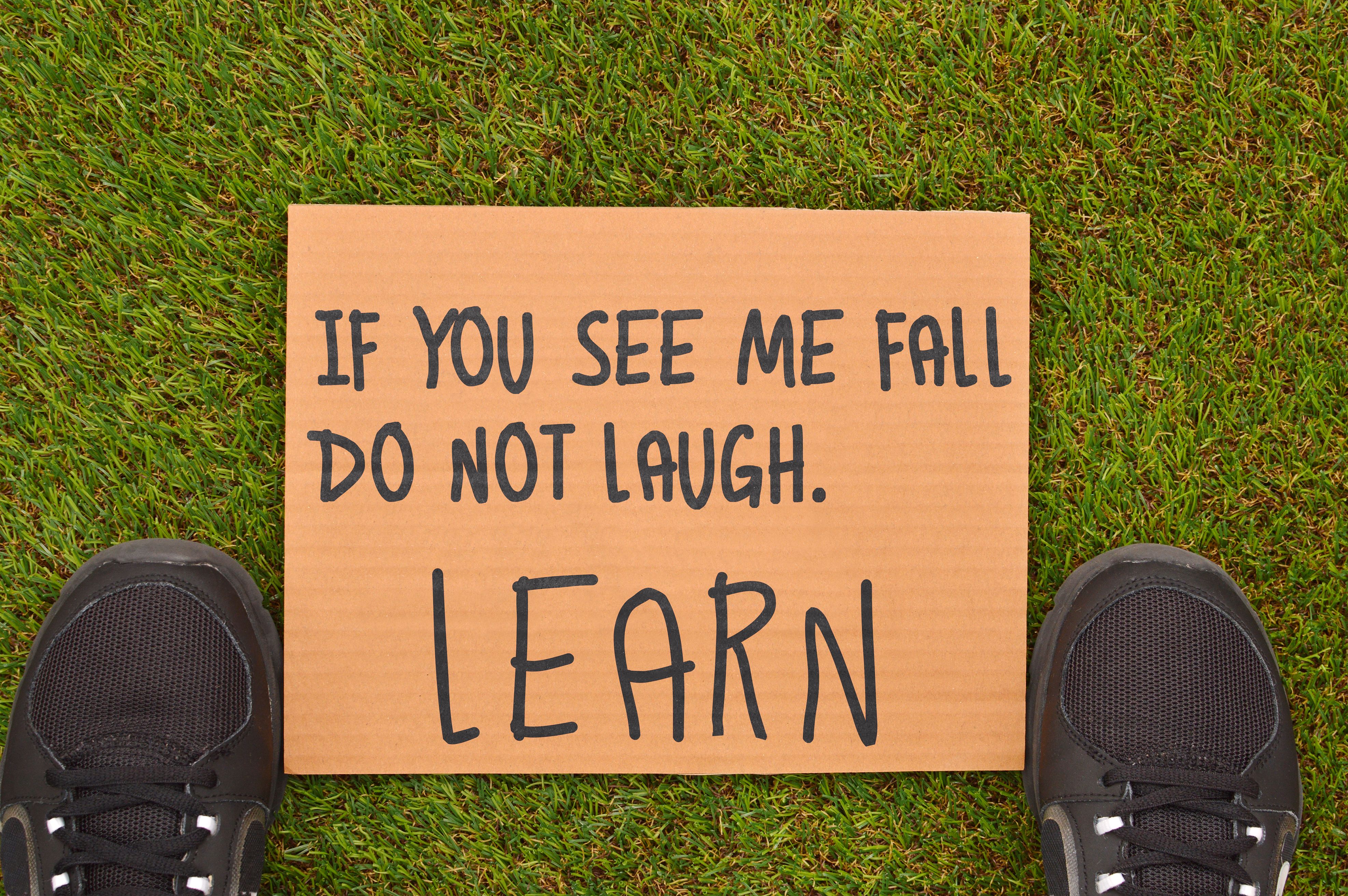 Inspirational Sign on Grass with Sneakers · Free Stock Photo