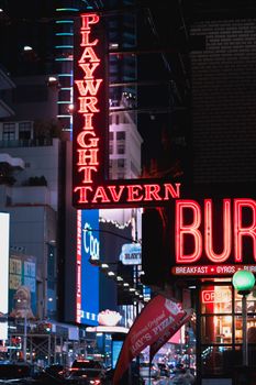Bright neon signs and city nightlife in Times Square, New York City.