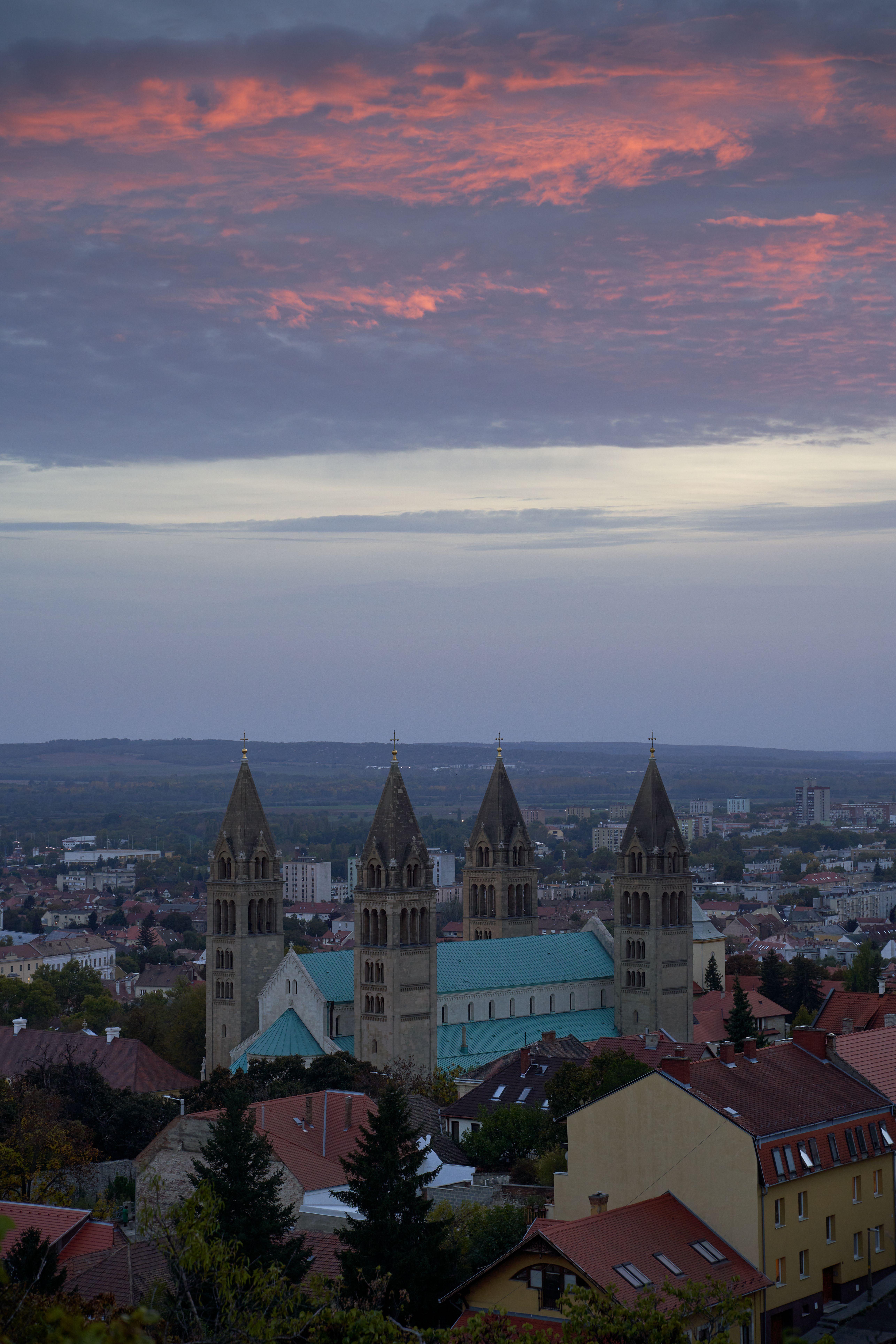 Pécs Cathedral stands against a dramatic twilight sky, showcasing Hungary's rich cultural heritage.