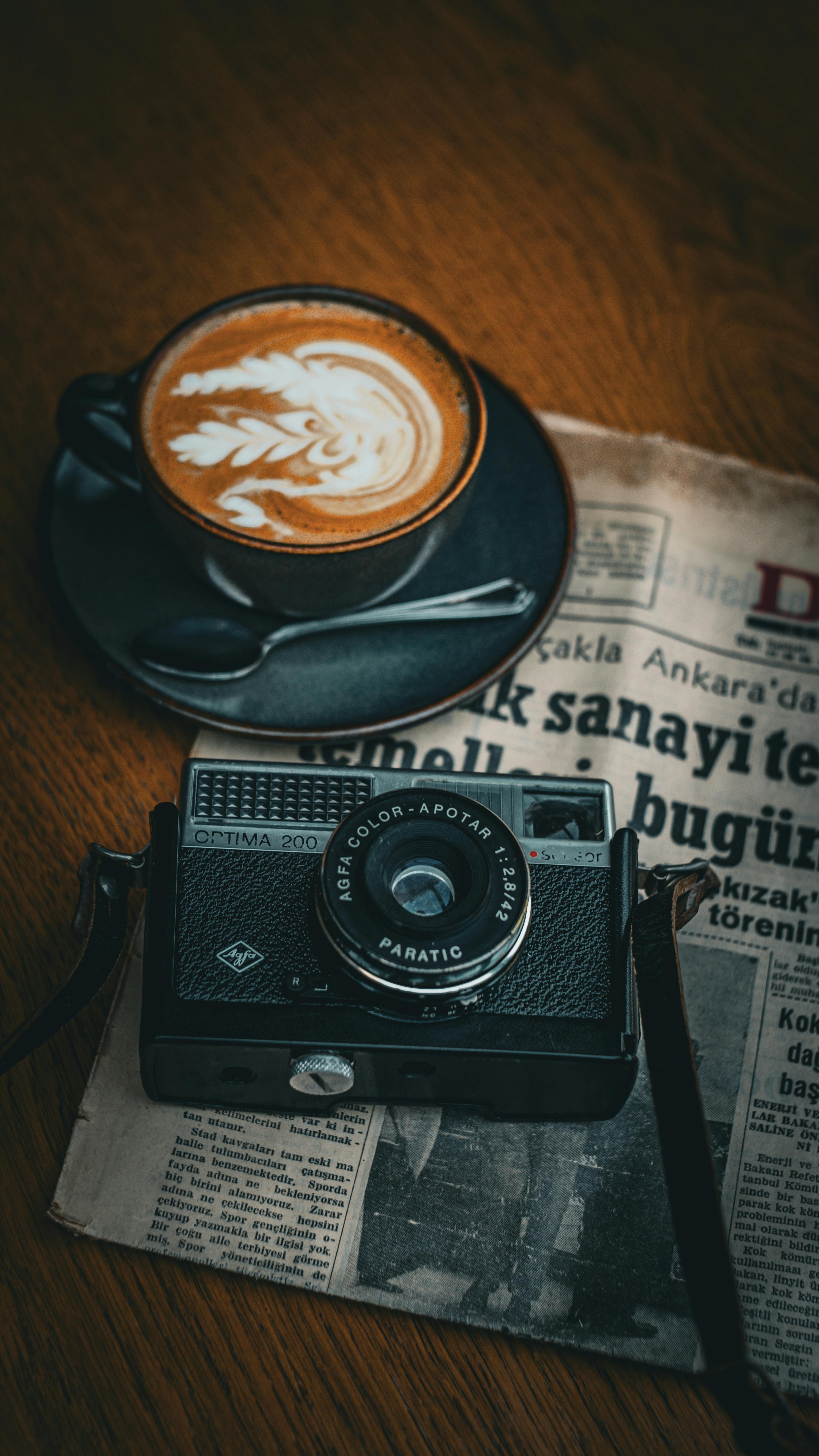 Vintage Camera with Latte Art and Newspaper Scene · Free Stock Photo