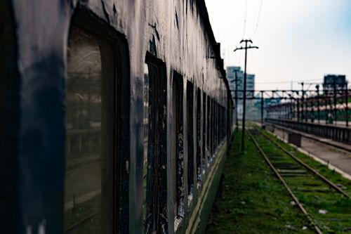 Free An old train carriage sits at an urban railway station, evoking nostalgia for past travels. Stock Photo