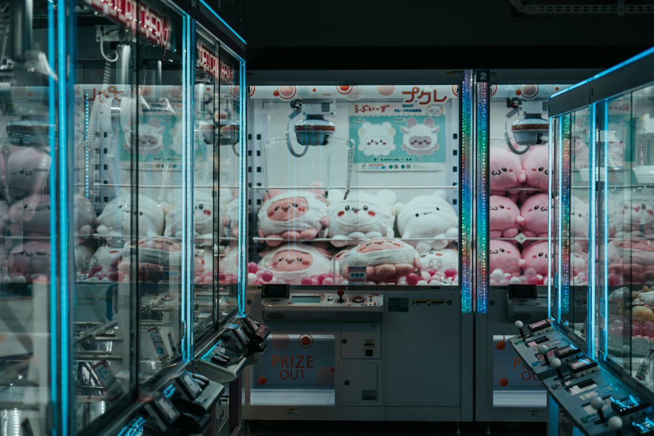 a vibrant shot of japanese arcade claw machines filled with plush toys