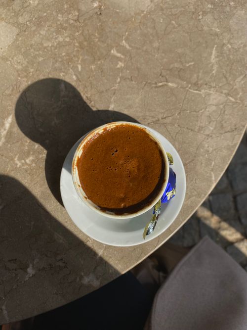 Free Top view of a Turkish coffee served on a stone table with shadows cast by sunlight. Stock Photo