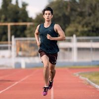Runner on a track at dusk — Ernest Flowers on Pexels