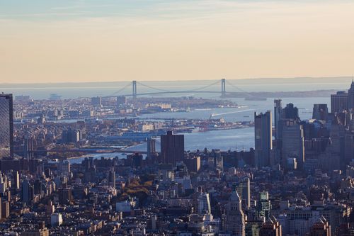 Free A breathtaking aerial view of New York City skyline with the iconic Verrazzano-Narrows Bridge in the background. Stock Photo