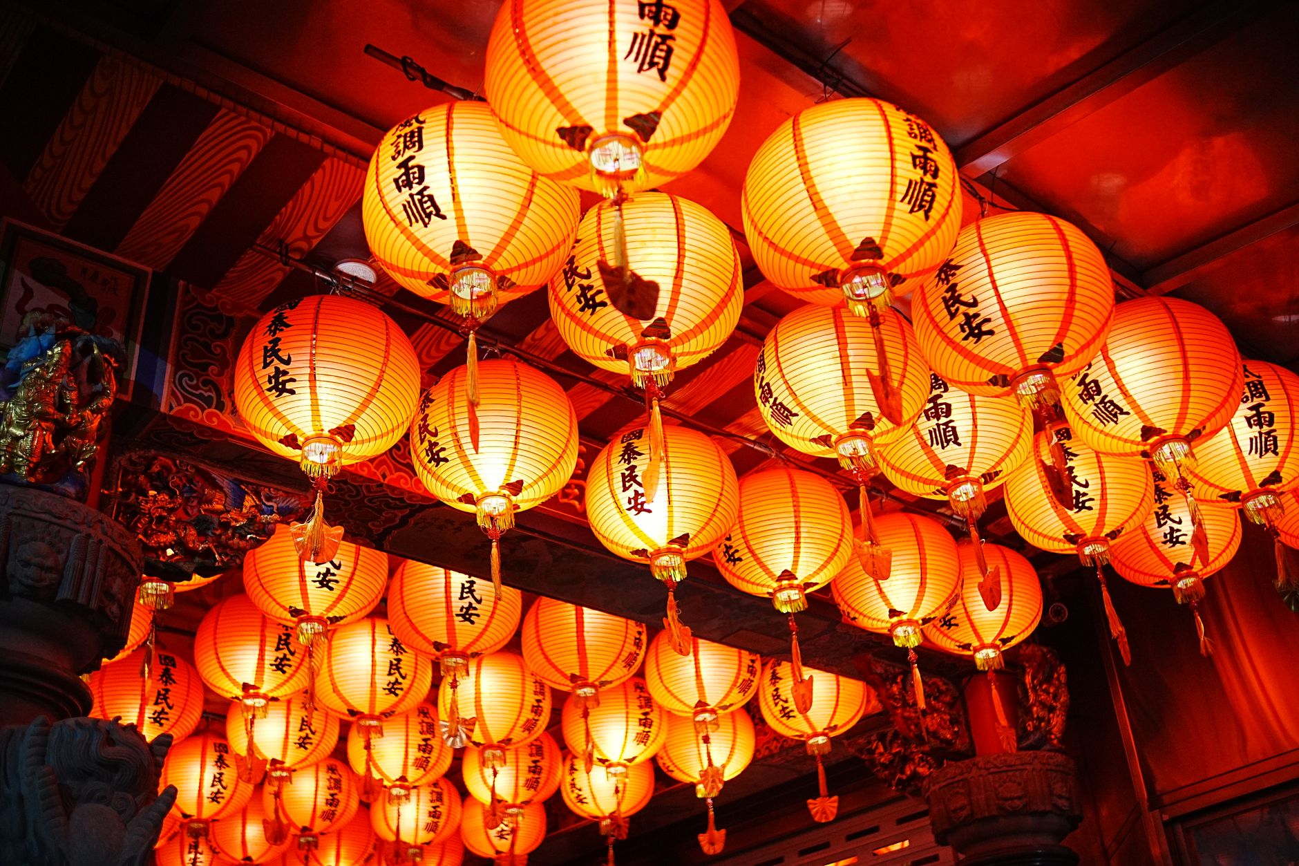 Bright red lanterns illuminate a traditional Taiwanese temple, showcasing cultural richness and vibrant design.