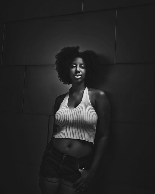 Free Artistic black and white portrait of a woman with afro hairstyle, in thoughtful pose. Stock Photo