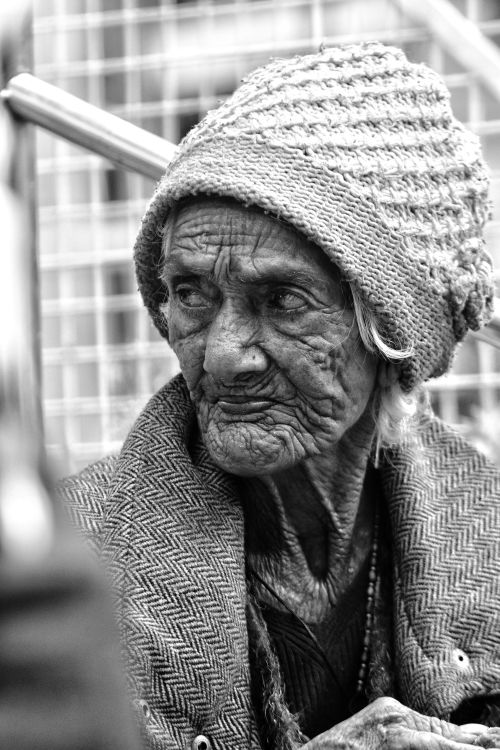 Free Black and white portrait of an elderly woman in Nainital, India, showcasing rich textures and cultural attire. Stock Photo