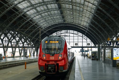 Free A striking red train at Leipzig Central Station, showcasing the architectural dome and bustling atmosphere. Stock Photo