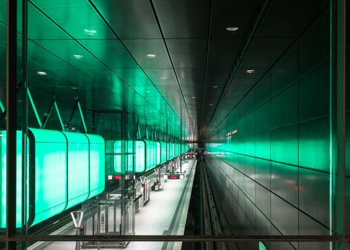 Free Modern subway station in Hamburg with vibrant green lighting and sleek architecture. Stock Photo