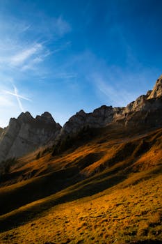 Captivating sunset over the Swiss Alps in Walenstadt, showcasing dramatic mountainous terrain and a vibrant sky.