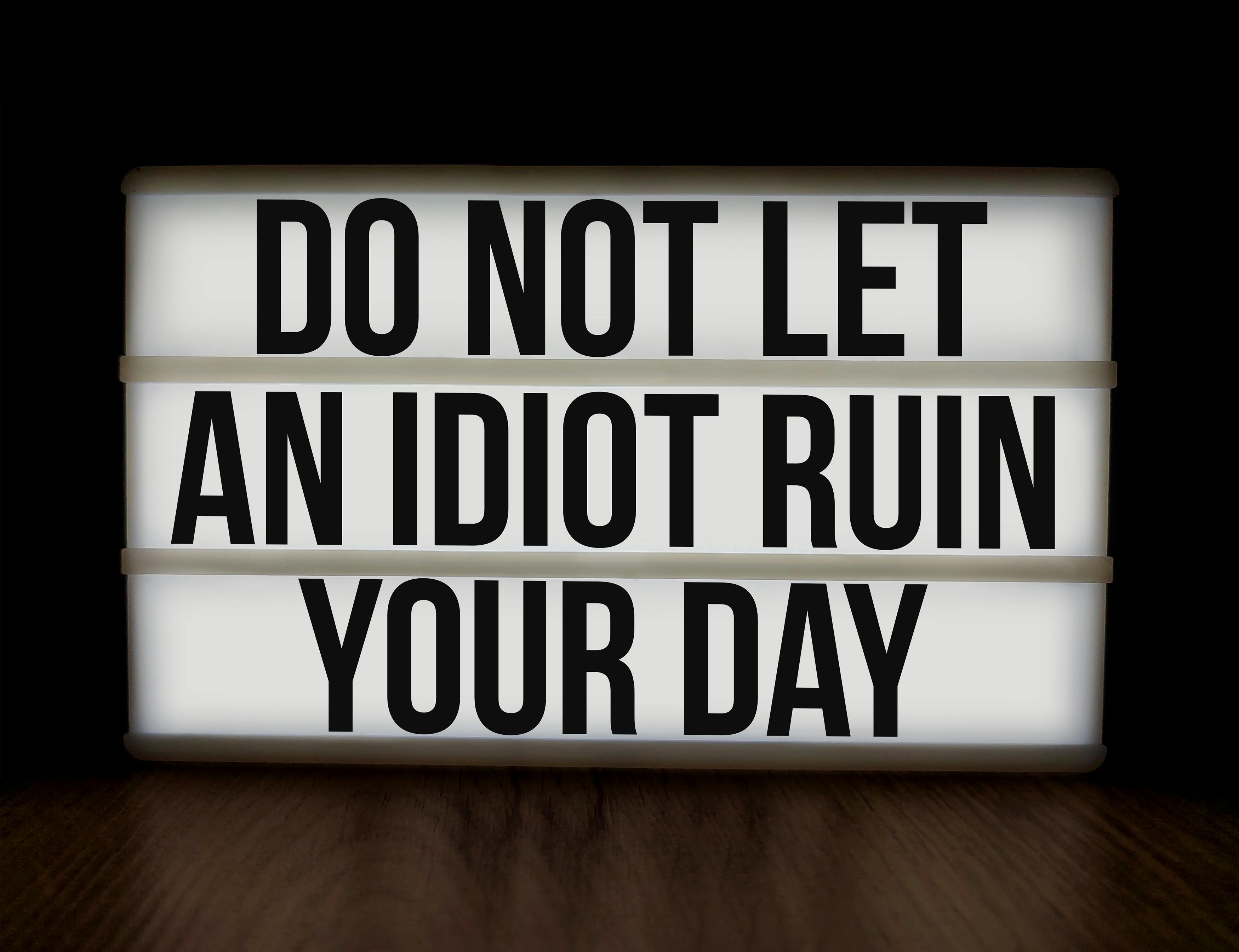 Inspirational message on a lightbox reminding you to stay positive against negativity.