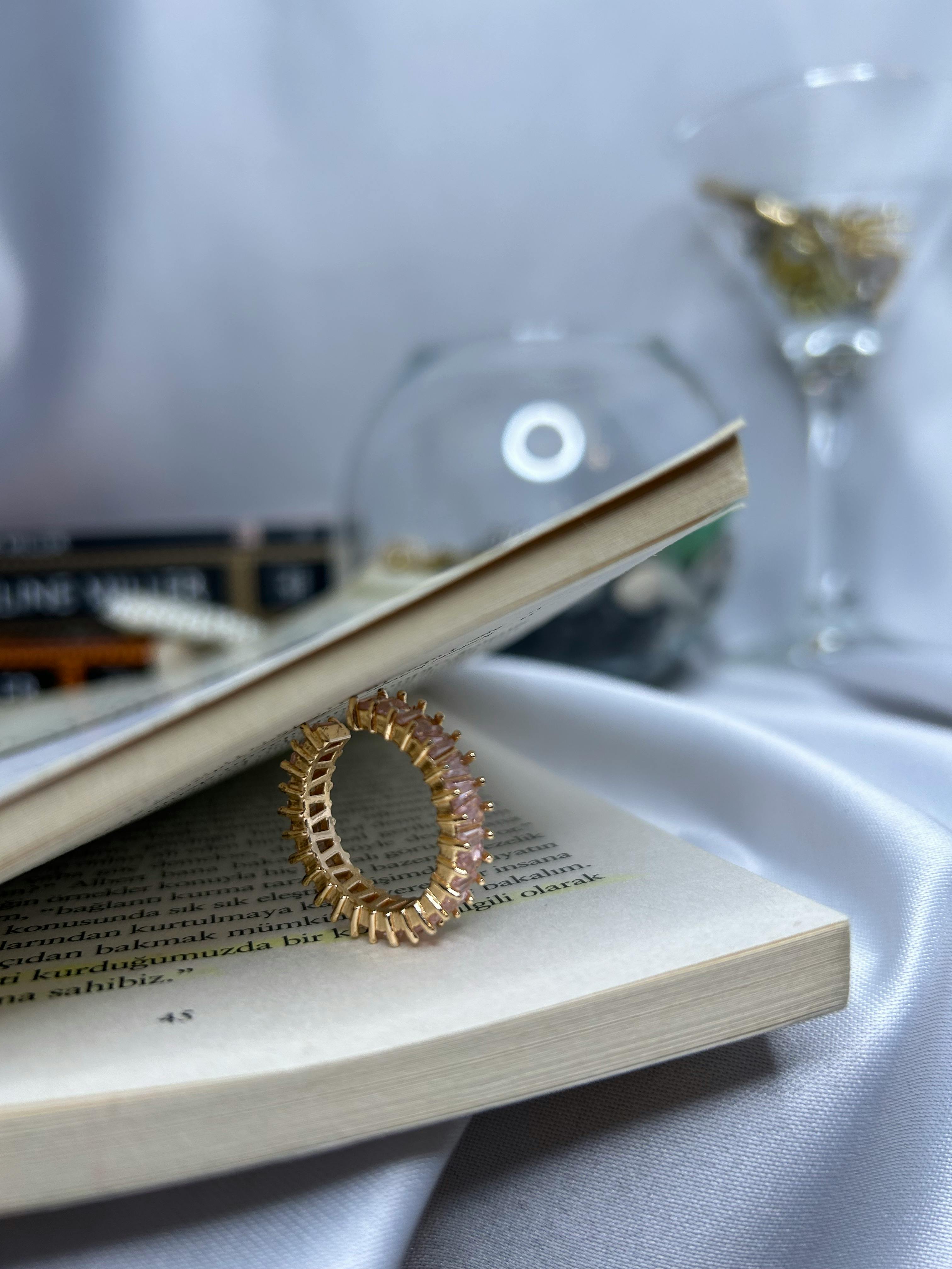 elegant gold ring on book with soft background