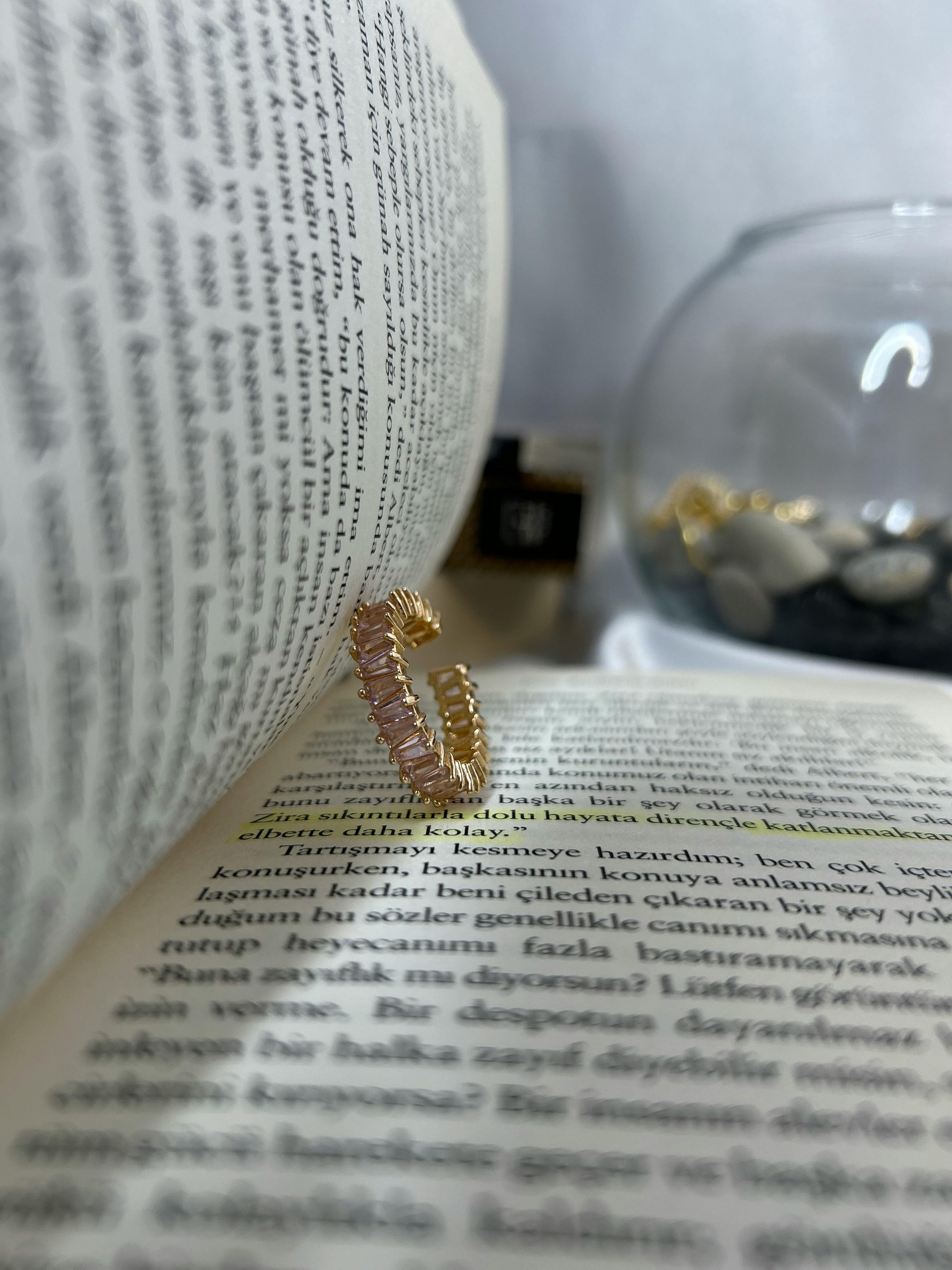 elegant gold ring with open book and glass bowl