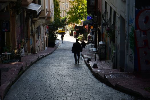 A scenic street in Istanbul with shadows and vibrant urban details.