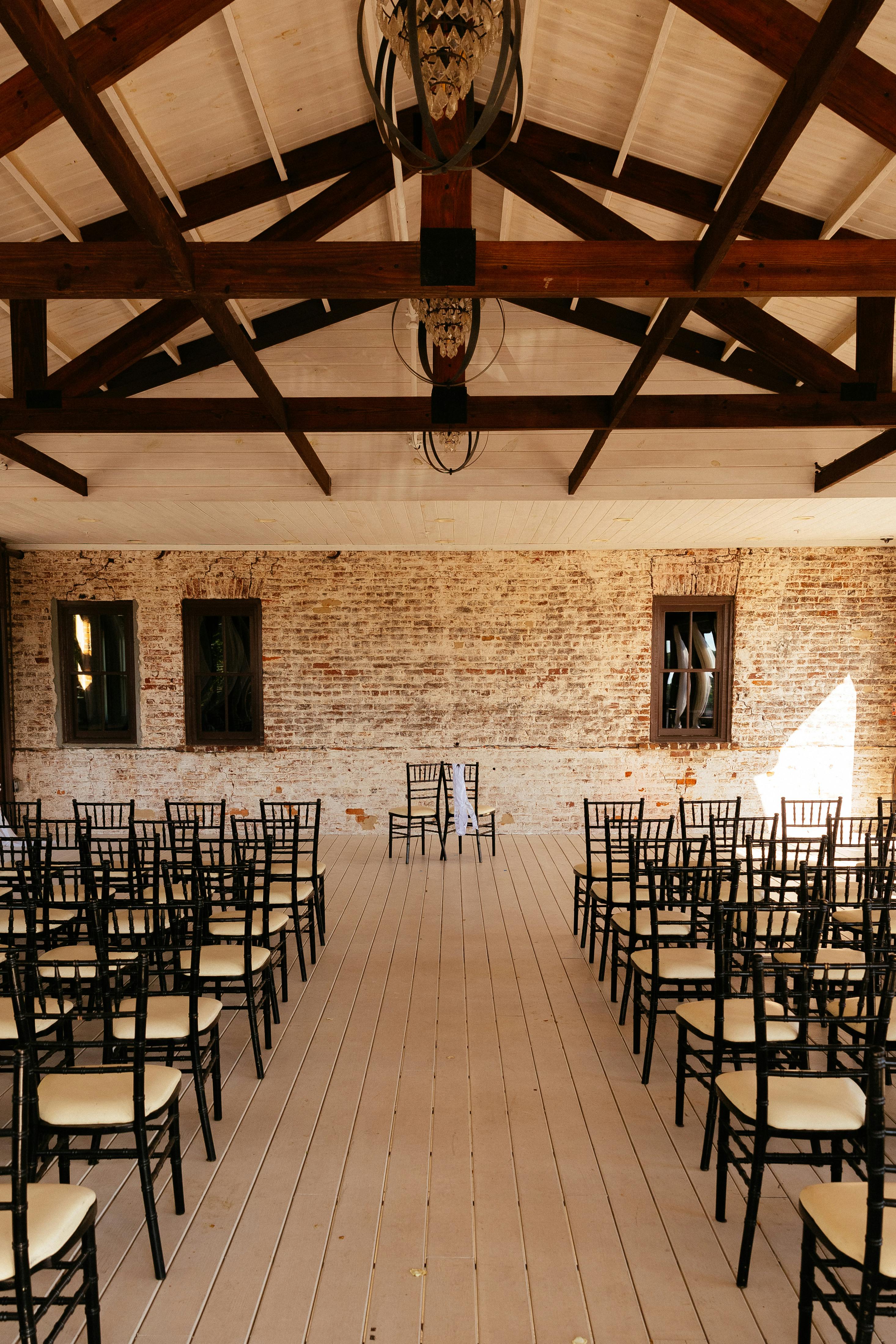 Elegant wedding venue in Acworth, GA featuring rustic decor and black chairs, ideal for ceremonies.