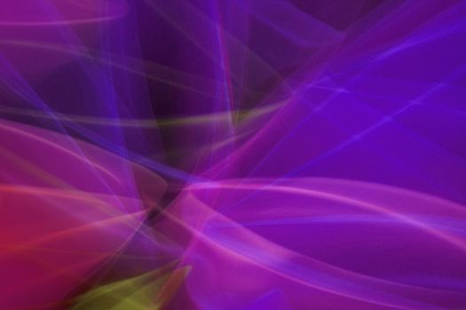 Vibrant abstract image of colorful light trails in motion with purple, pink, and yellow hues.
