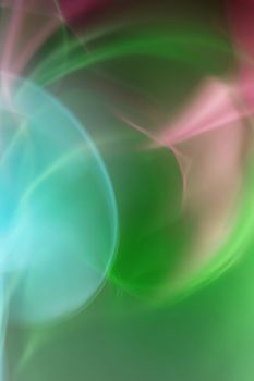 Colorful abstract light swirls create a dynamic, ethereal effect.