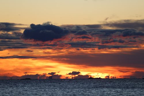 Free Captivating sunrise with vibrant autumn colors and cloud formations over Stamford waters. Stock Photo
