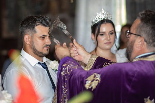 Bride and groom during a traditional wedding crowning ceremony indoors.