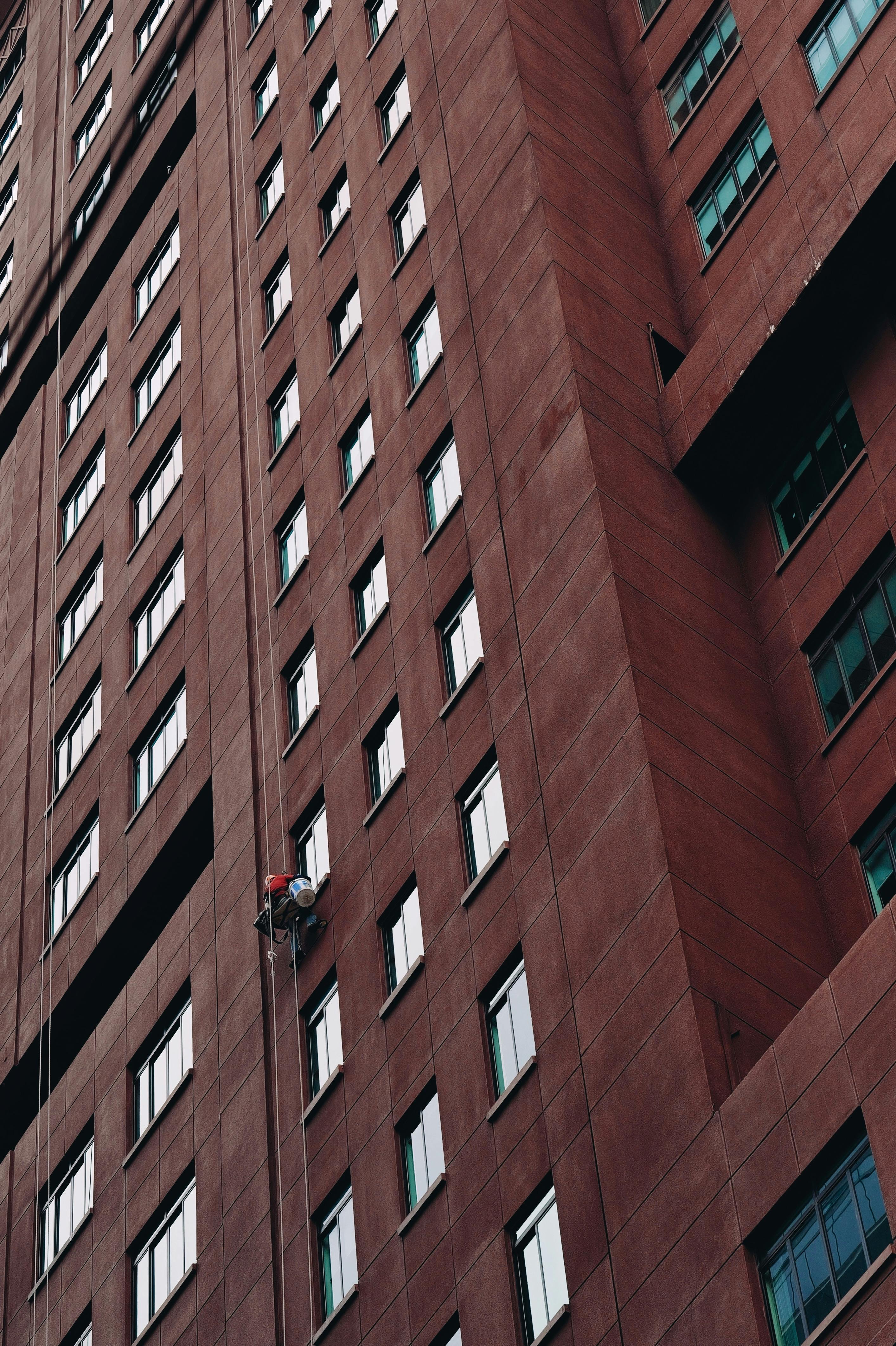 high rise building facade with window cleaner