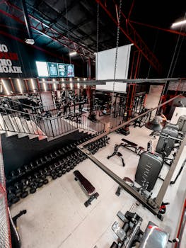 Spacious gym interior featuring a variety of fitness equipment and weights, perfect for workouts.