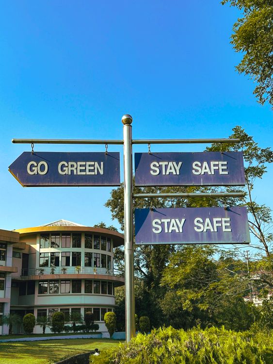 Directional Sign with Environmental Message Outdoors · Free Stock Photo