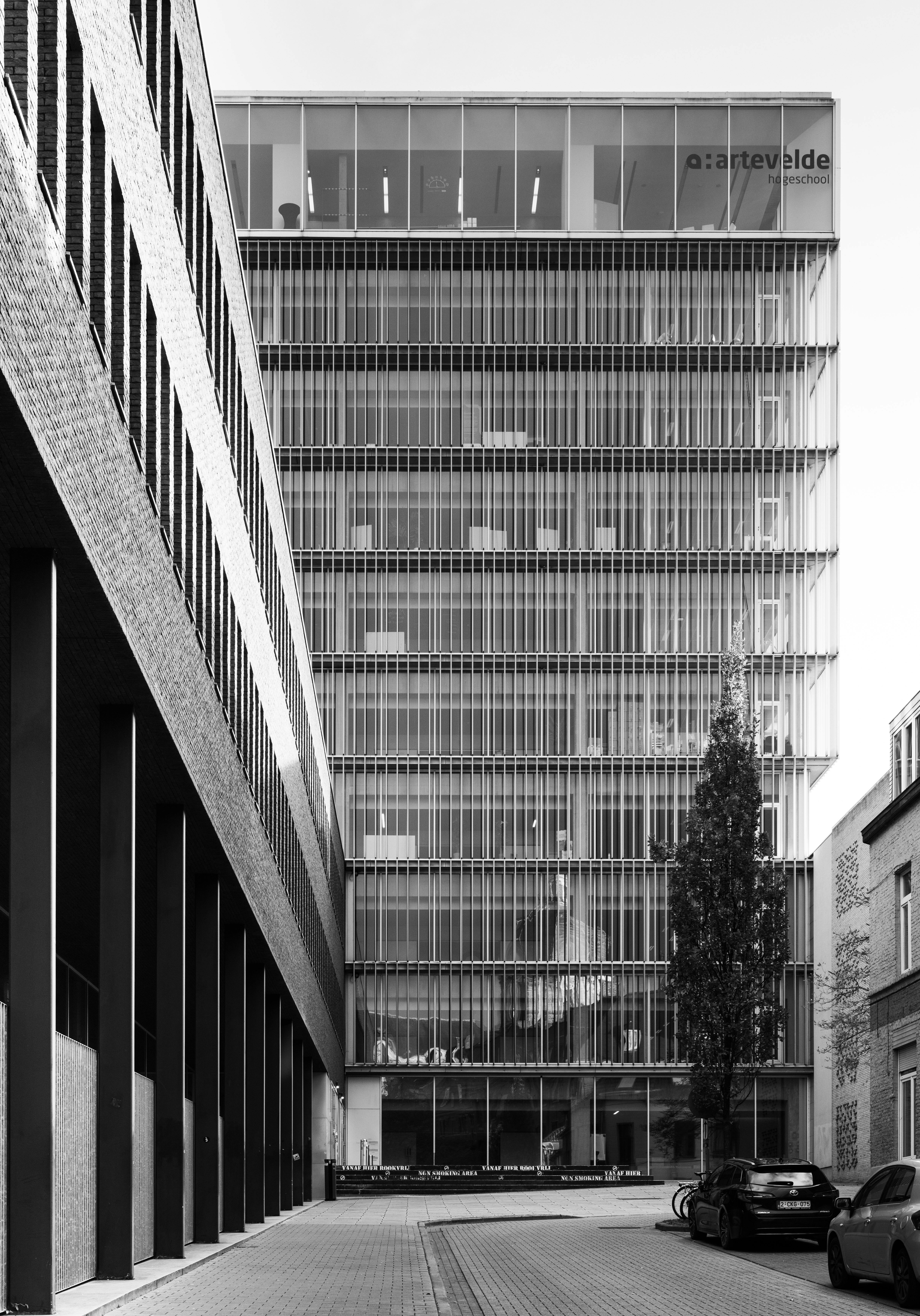 Black and white photo of a modern building in Ghent, showcasing urban architecture.