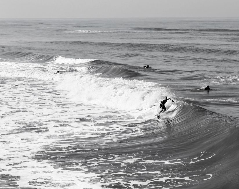 Surfer skillfully navigating a wave at Mongaguá beach, Brazil.