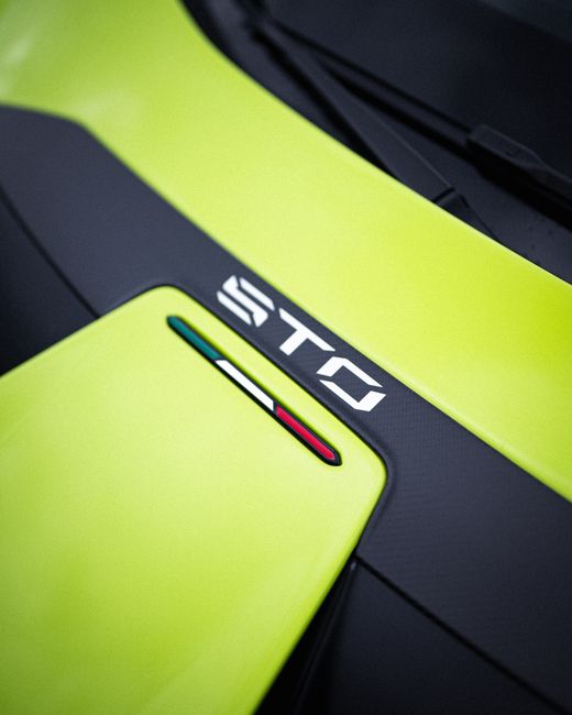 Close-up of Lamborghini Huracan STO with vibrant lime color and sleek design.