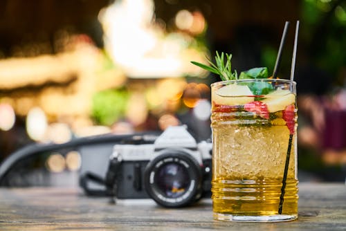 Free Close-up Of A Cocktail Drink Near Slr Camera Stock Photo