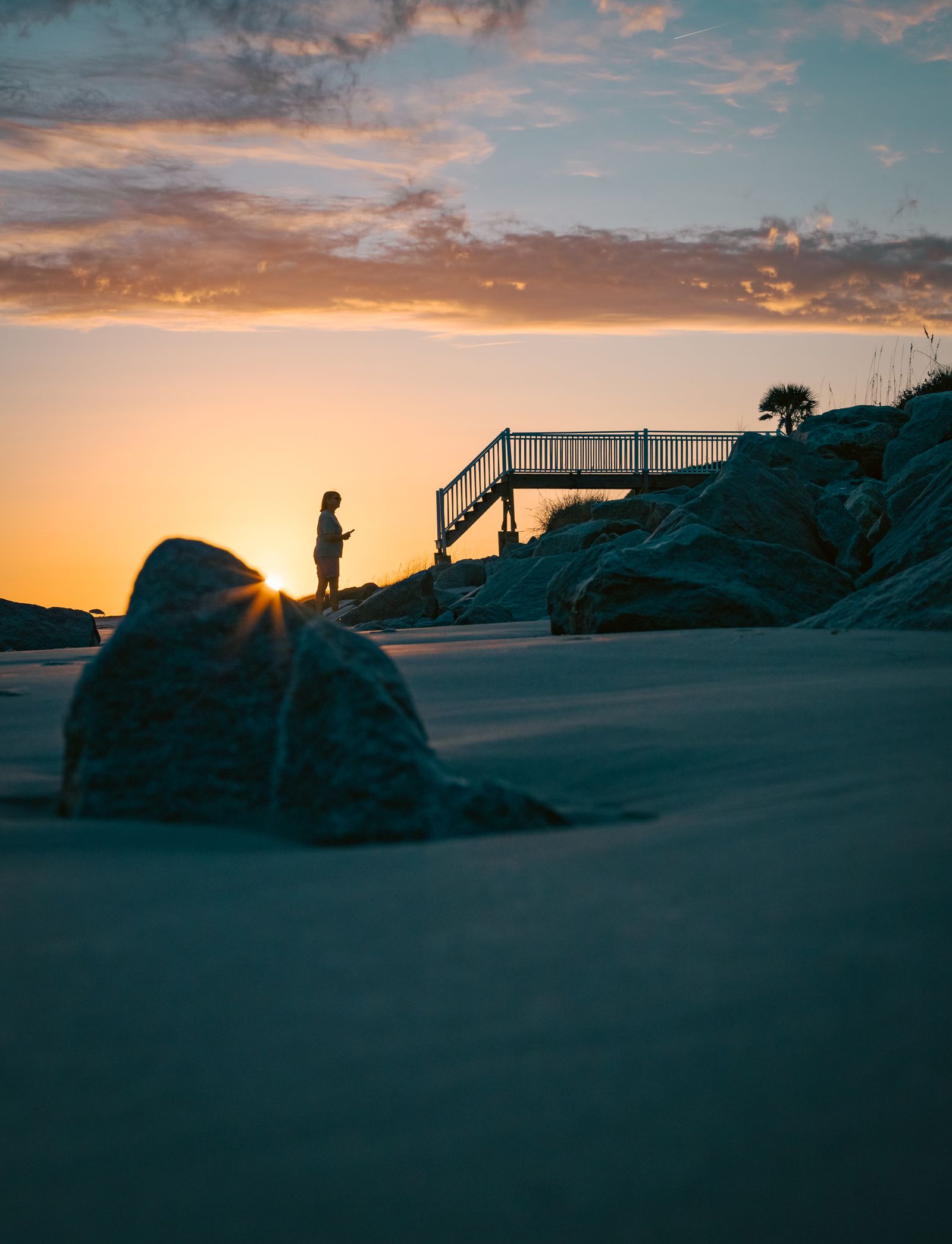Silhouette of a person at the beach during sunset
